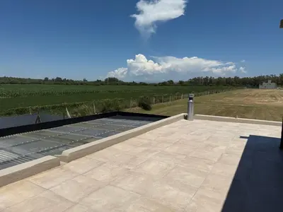 a patio with a view of a vineyard and blue sky at HOUSE SOUTH en AQUAVISTA VILLA RESIDENCIAL in Malagueño