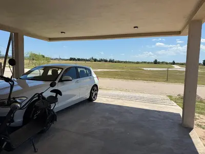a white car is parked in a garage at HOUSE SOUTH en AQUAVISTA VILLA RESIDENCIAL in Malagueño