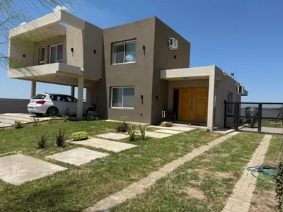 a house with a car parked in front of it at HOUSE SOUTH en AQUAVISTA VILLA RESIDENCIAL in Malagueño