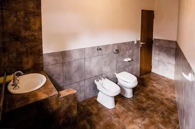 a bathroom with a toilet and a sink at Monoambiente los ceibos in Villa Santa Cruz del Lago