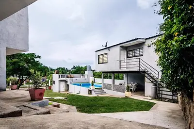 a house with a swimming pool in the yard at Monoambiente los ceibos in Villa Santa Cruz del Lago