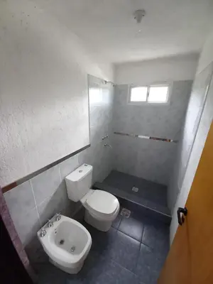 a bathroom with a toilet and a bidet at Casita los ceibos in Villa Santa Cruz del Lago