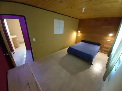 a bedroom with a blue bed in a room at Casita los ceibos in Villa Santa Cruz del Lago