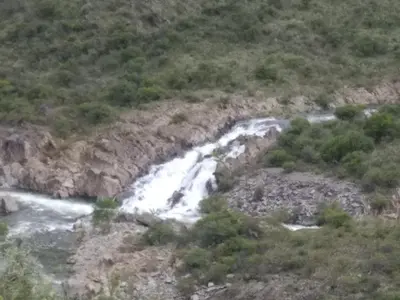 a waterfall on the side of a mountain at La tranquera ll in Trapiche