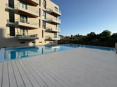 a building with a swimming pool in front of a building at Departamento en Villa Carlos Paz in Villa Carlos Paz