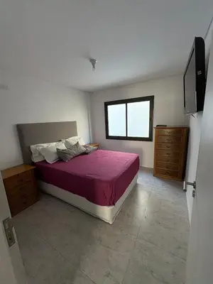 a bedroom with a large bed and a window at Departamento en Villa Carlos Paz in Villa Carlos Paz