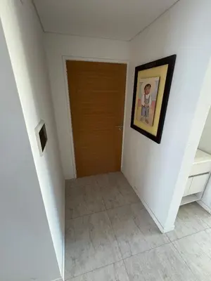 a hallway with a door and a picture on the wall at Departamento en Villa Carlos Paz in Villa Carlos Paz