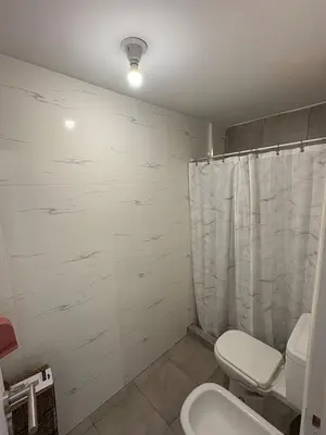 a bathroom with a toilet and a sink at Departamento en Villa Carlos Paz in Villa Carlos Paz