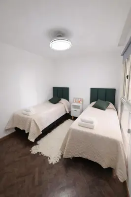two beds sitting in a room with at Teacher Grace - Departamento 2 dormitorios en Nueva Córdoba in Cordoba