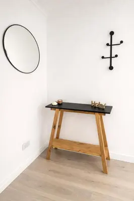 a table in a room with a mirror and crosses at Teacher Grace - Departamento 2 dormitorios en Nueva Córdoba in Cordoba