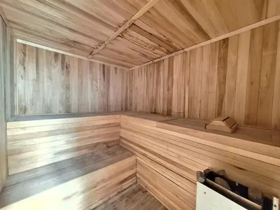 an empty wooden sauna with a bench in it at Dpto Premium Costanera cochera y patio privado in Villa Carlos Paz