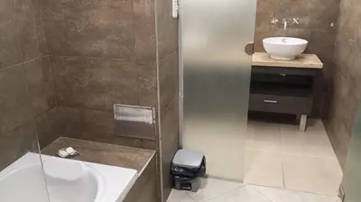 a bathroom with a sink and a toilet and a shower at Dpto Premium Costanera cochera y patio privado in Villa Carlos Paz