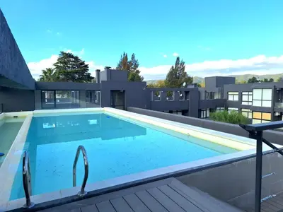 a swimming pool on the roof of a building at Dpto Premium Costanera cochera y patio privado in Villa Carlos Paz