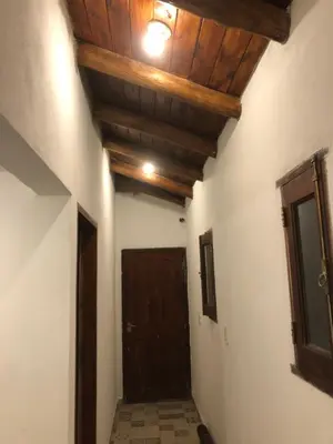 a hallway with a wooden ceiling and a door at Los árboles in Cordoba