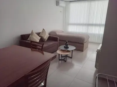 a living room with a couch and a table at Departamento Paseo Quattro in Villa Carlos Paz