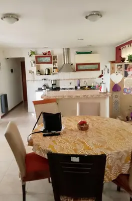 a kitchen with a table and chairs and a kitchen with a kitchen at Casa Nacha in Cuesta Blanca