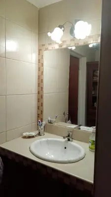 a bathroom with a sink and a large mirror at Casa Nacha in Cuesta Blanca