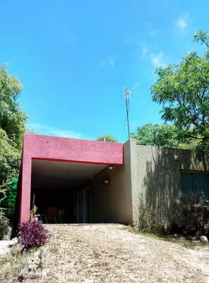 a building with a pink cover on the side of it at Casa Nacha in Cuesta Blanca