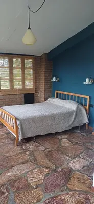 a bedroom with a large bed in a blue wall at naulitus in Villa Icho Cruz