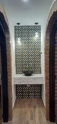 a bathroom with a sink on a wall at naulitus in Villa Icho Cruz