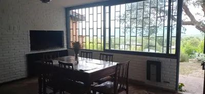 a dining room with a table and a large window at naulitus in Villa Icho Cruz