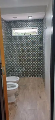a bathroom with a toilet and a window at naulitus in Villa Icho Cruz