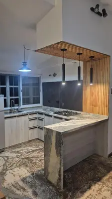 a large kitchen with a large marble counter top at naulitus in Villa Icho Cruz