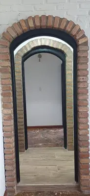 a brick fireplace with a mirror on top of it at naulitus in Villa Icho Cruz