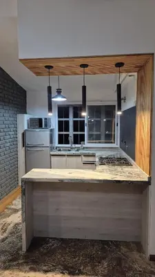 a kitchen with a large island in the middle at naulitus in Villa Icho Cruz