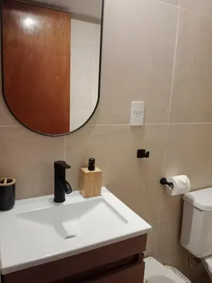 a bathroom with a white sink and a mirror at Encantador departamento en Nueva Córdoba in La Porteña