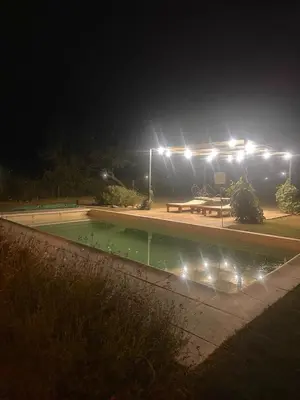 a swimming pool at night with lights in a park at Casa Valle del Colibrí in Merlo