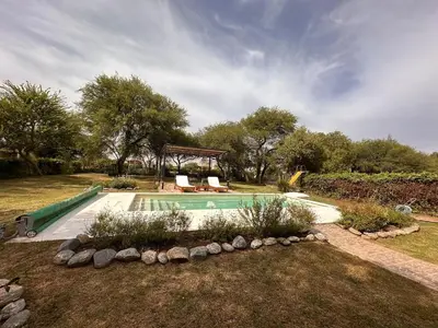 a swimming pool in a yard with at Casa Valle del Colibrí in Merlo
