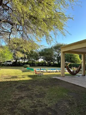a picnic table and a hammock in a park at Casa Valle del Colibrí in Merlo