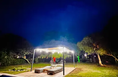 a gazebo in a yard at night at Casa Valle del Colibrí in Merlo