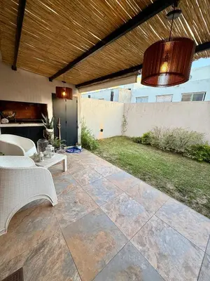 a patio with a wooden ceiling and a pendant light at Estilo y Relax en Manantiales ll in Cordoba
