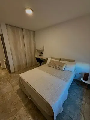 a bedroom with a large bed and a desk at Estilo y Relax en Manantiales ll in Cordoba