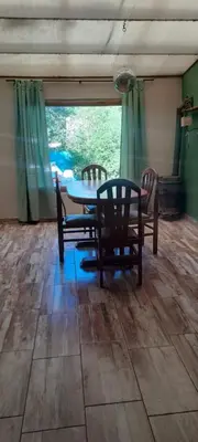 a dining room with a table and chairs and a window at Buena tierra in Arroyo de Los Patos