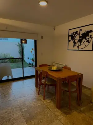 a dining room with a wooden table and chairs at Estilo y Relax en Manantiales ll in Cordoba
