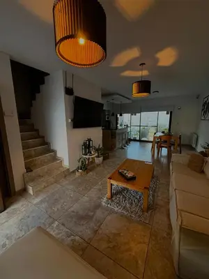 a living room with a couch and a table at Estilo y Relax en Manantiales ll in Cordoba