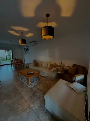 a living room with a couch and a table at Estilo y Relax en Manantiales ll in Cordoba
