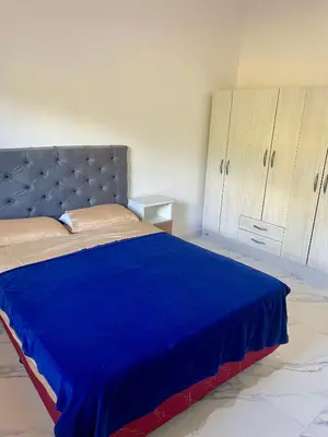 a bedroom with a bed with a blue blanket on it at Las Mariposas in Merlo