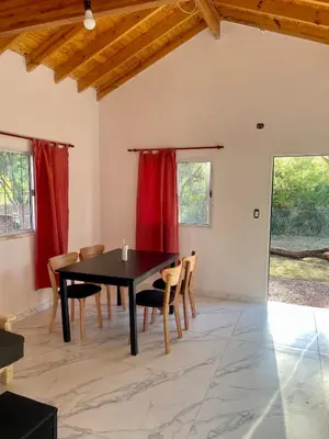 a dining room with a black table and chairs at Las Mariposas in Merlo