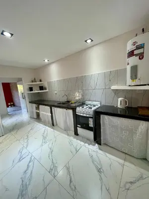 a kitchen with white marble flooring and a stove at Las Mariposas in Merlo