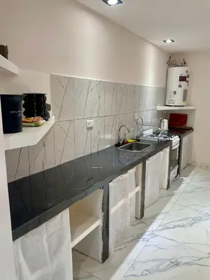 a kitchen with a black counter and a sink at Las Mariposas in Merlo