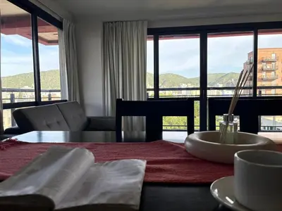 a dining room table with a view of a building at Hermoso departamento en el Centro de Carlos Paz in Villa Carlos Paz
