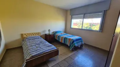 a bedroom with two beds and a window at El Tesoro Cordobés in Cordoba