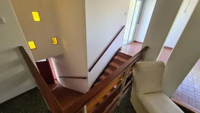 a staircase in a building with a chair and a stair case at El Tesoro Cordobés in Cordoba
