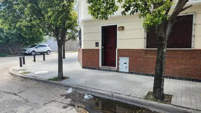 a building with a red door on a street at El Tesoro Cordobés in Cordoba