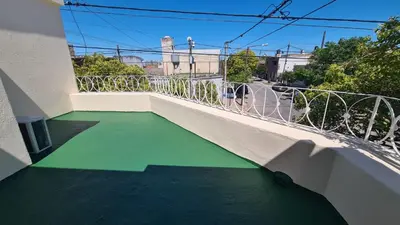 a balcony with a green floor and white railing at El Tesoro Cordobés in Cordoba
