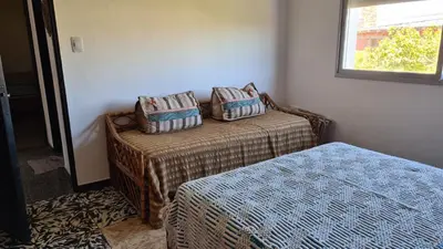 a room with two beds and a window at El Tesoro Cordobés in Cordoba